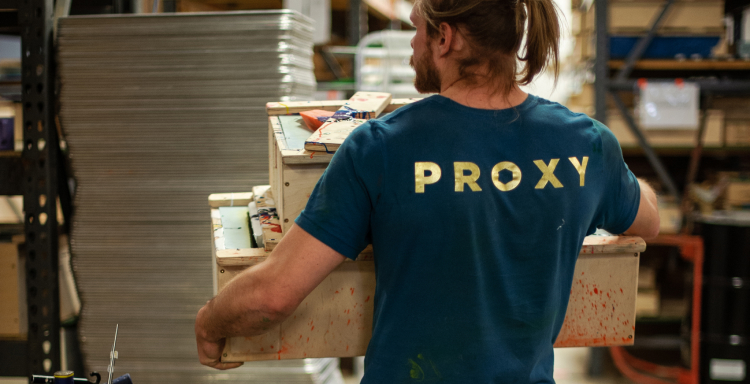 A Proxy employee carrying several climbing hold molds.
