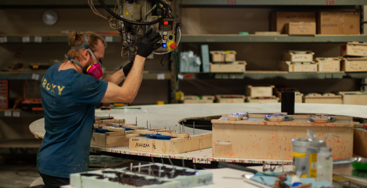A Proxy employee using a state of the art machine to pour climbing holds.