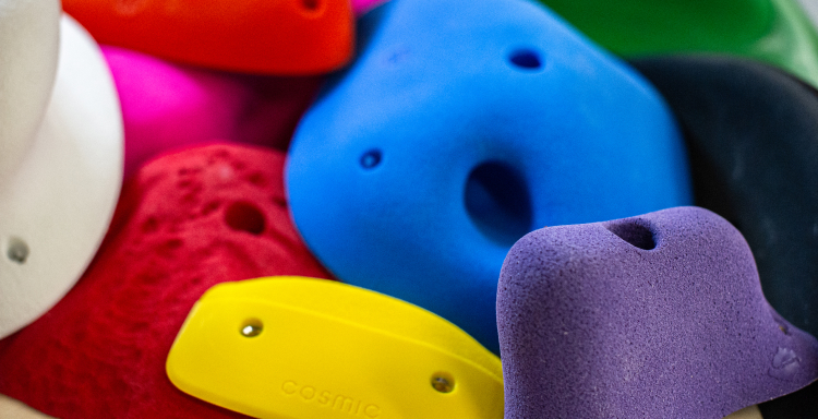 A variety of polyurethane climbing holds stacked on top of each other.
